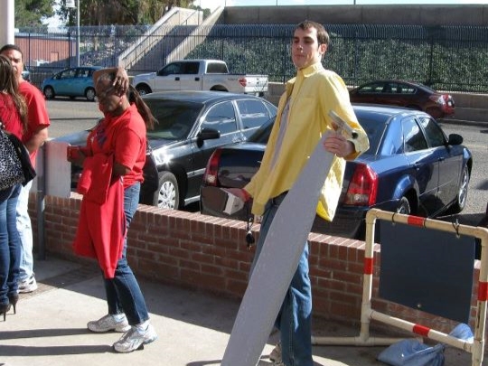 Standing outside of McKale Memorial Center with an ironing board in hand.